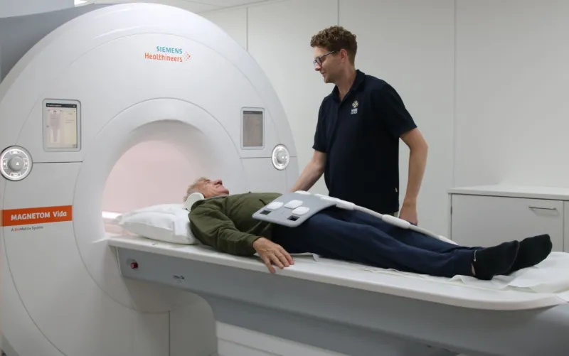 laborant met patient bij mri scanner